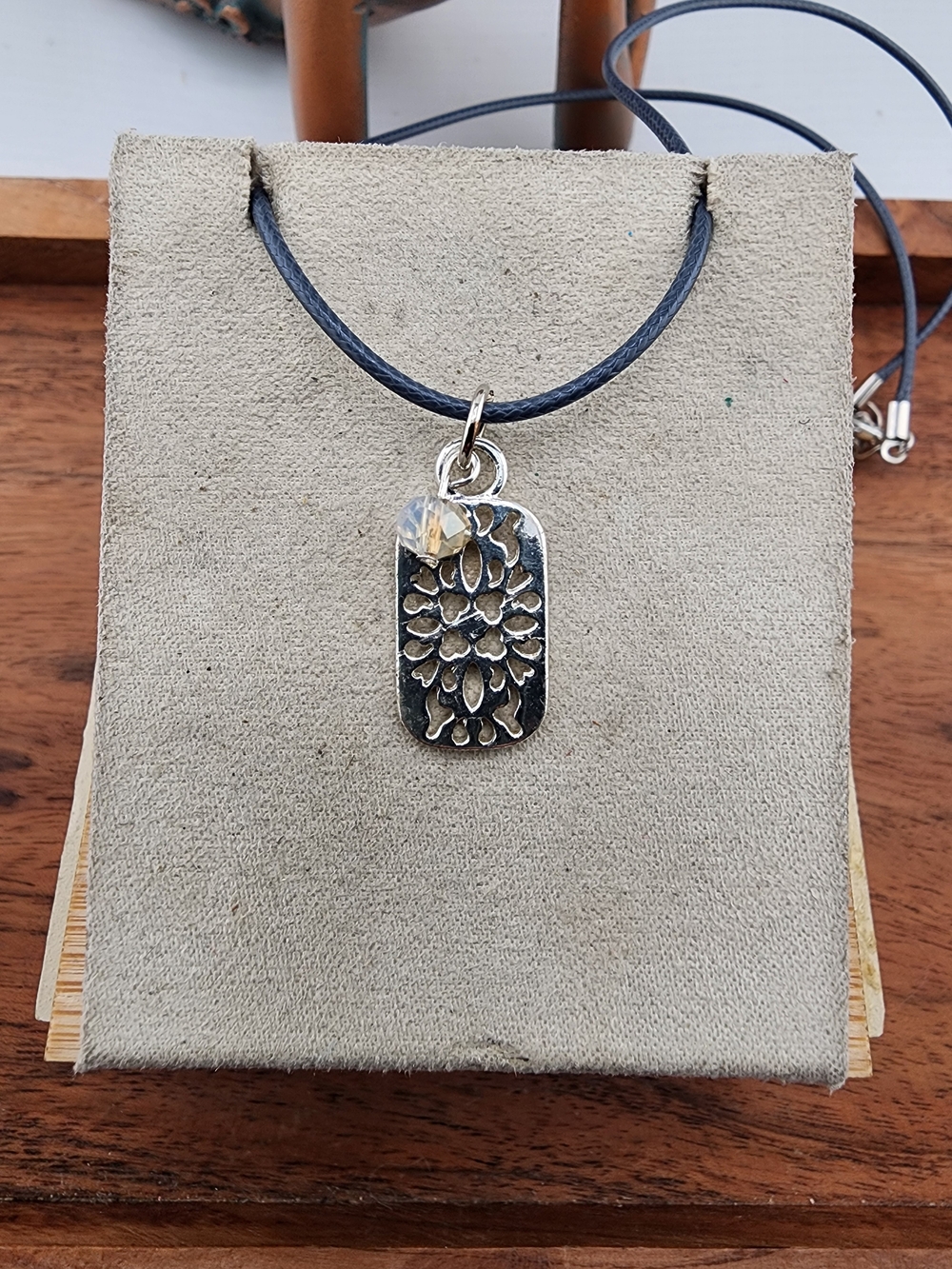 Black Cord Necklace with Silver Floral Pendant and Crystal Accent